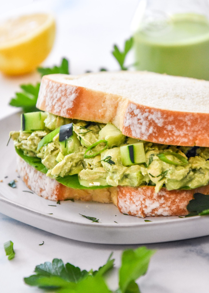 a green goddess tuna salad sandwich on white bread.