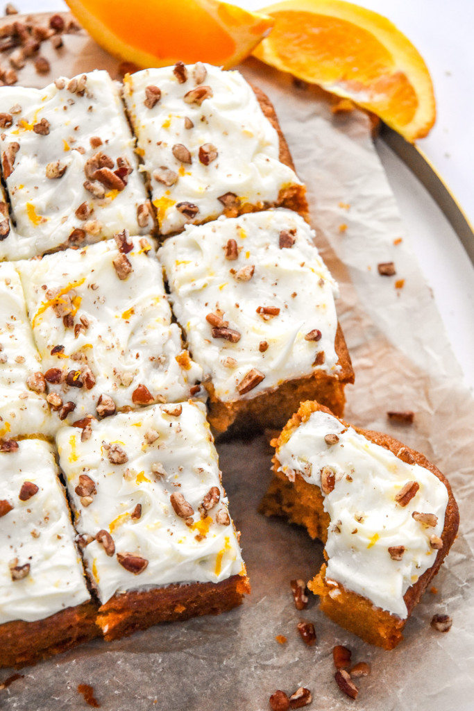 sweet potato spice cake with cream cheese frosting cut into pieces.