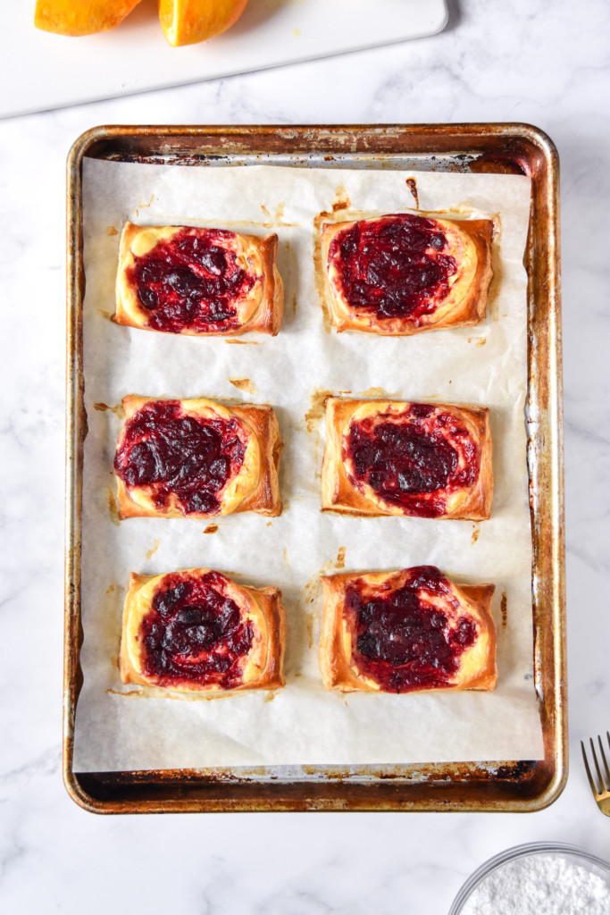fresh out of the oven leftover cranberry sauce cheese danish on a sheet pan.