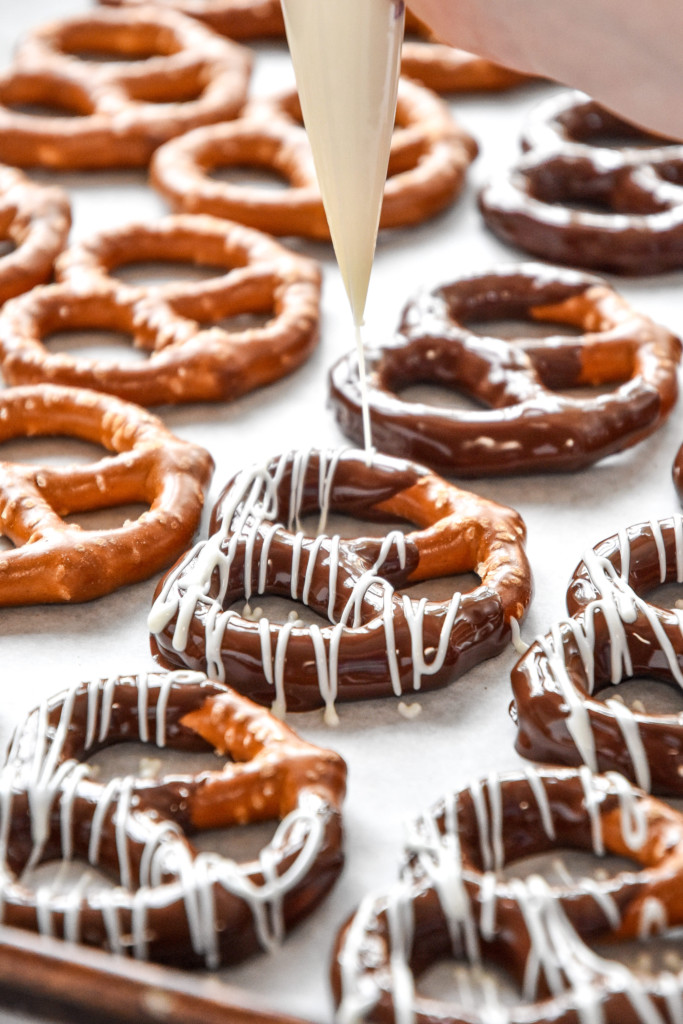 drizzling white chocolate on the pretzels already dipped in semi sweet chocolate.