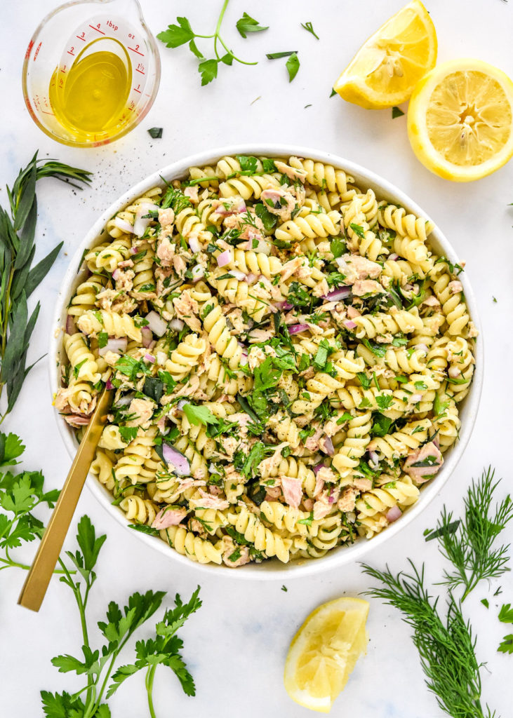 lemon vinaigrette tuna pasta salad with fresh herbs and lemons.