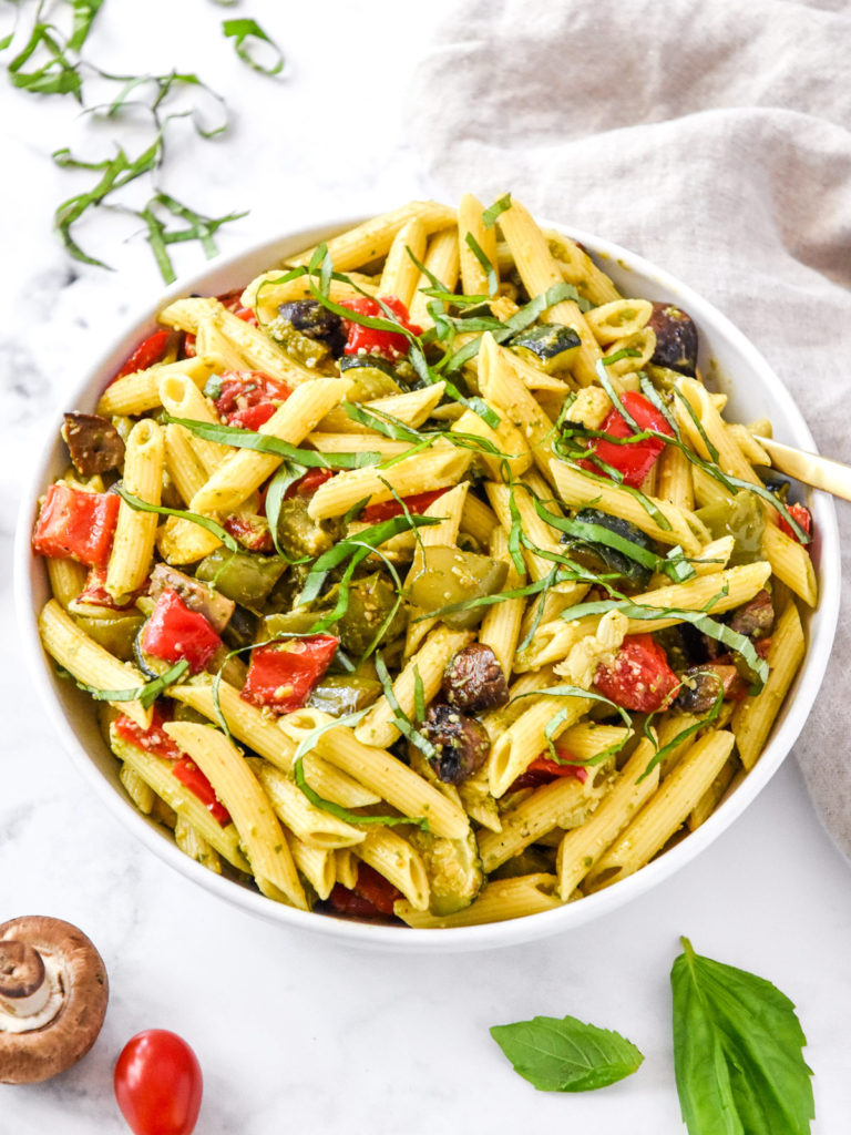 mixed roasted veggie pesto pasta in a large mixing bowl.