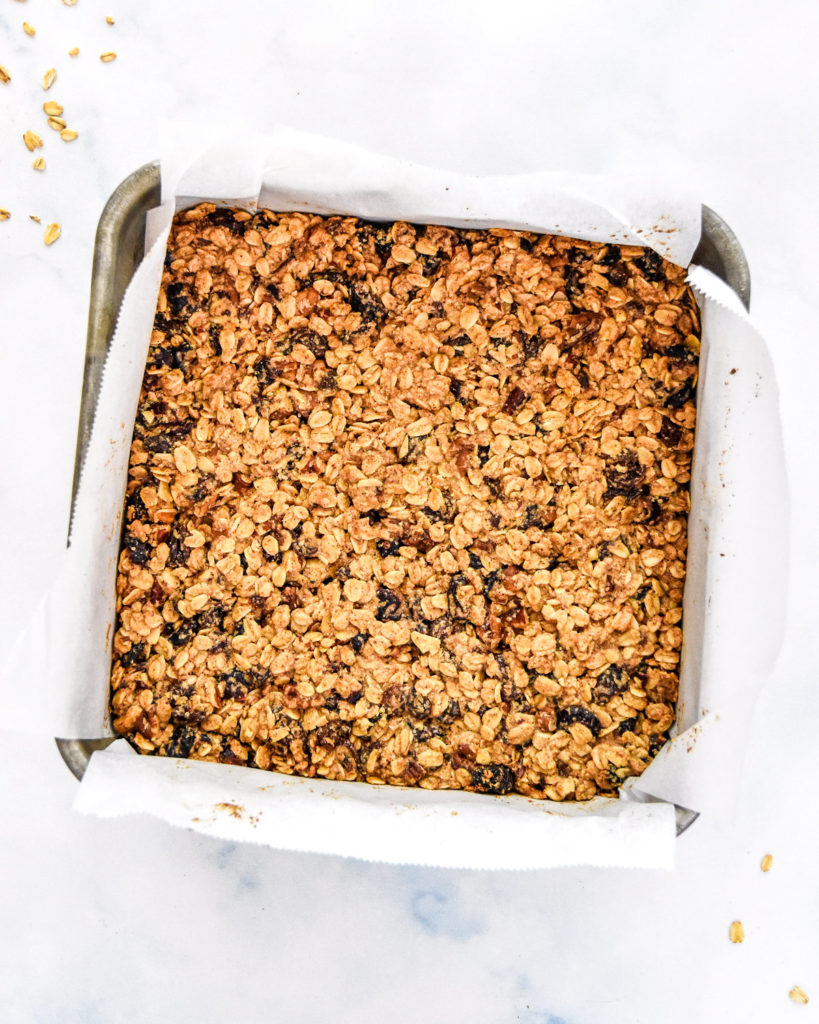 homemade baked chewy cinnamon granola bars in a metal baking pan.