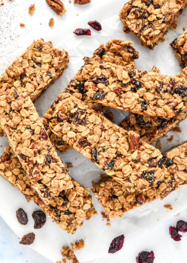 homemade chewy cinnamon granola bars cut on parchment paper.
