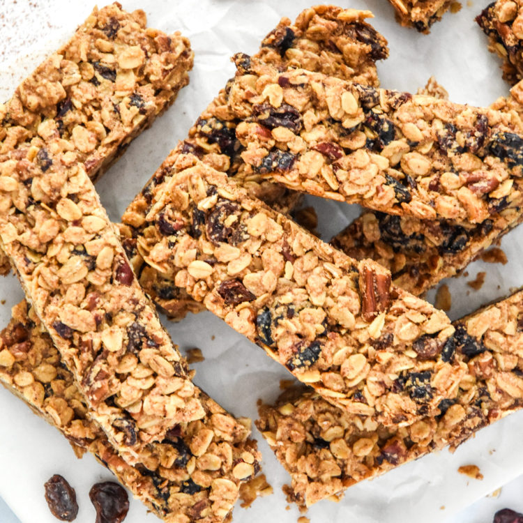 homemade chewy cinnamon granola bars cut on parchment paper.