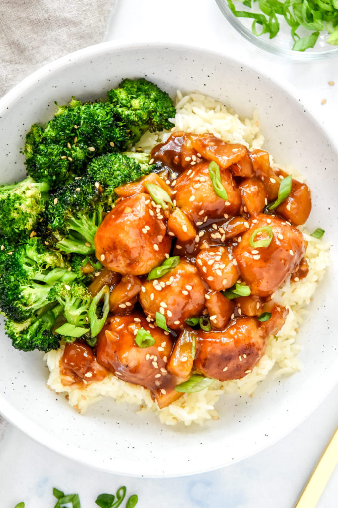 sticky saucy ground chicken meatballs with broccoli and rice in a bowl.