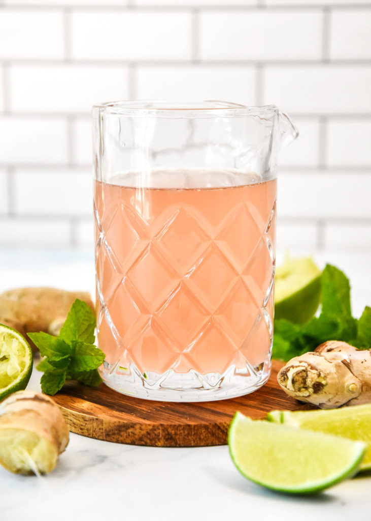 make-ahead ginger lime syrup in a glass pouring jug.