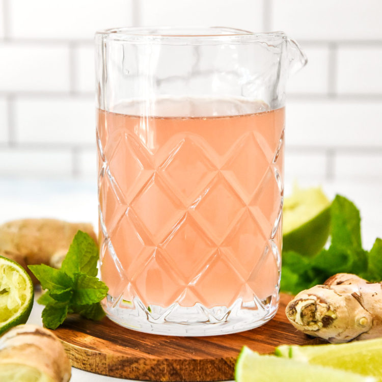make-ahead ginger lime syrup in a glass pouring jug.