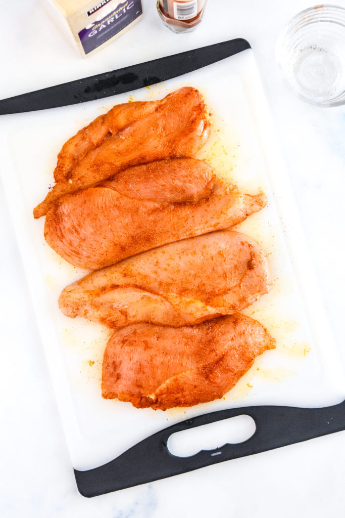 raw chicken with seasonings rubbed on before cooking.