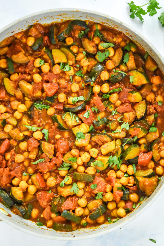 cooked zucchini chickpea curry in a large pan.