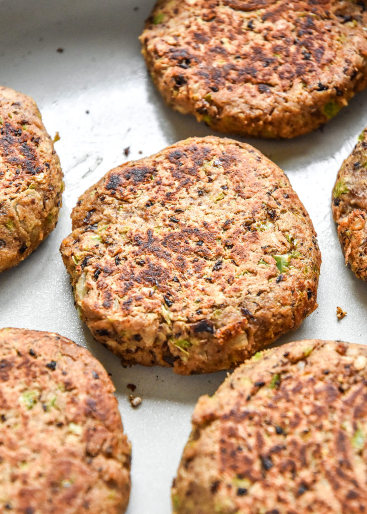 cooked black bean burger patties in a pan on the stove.