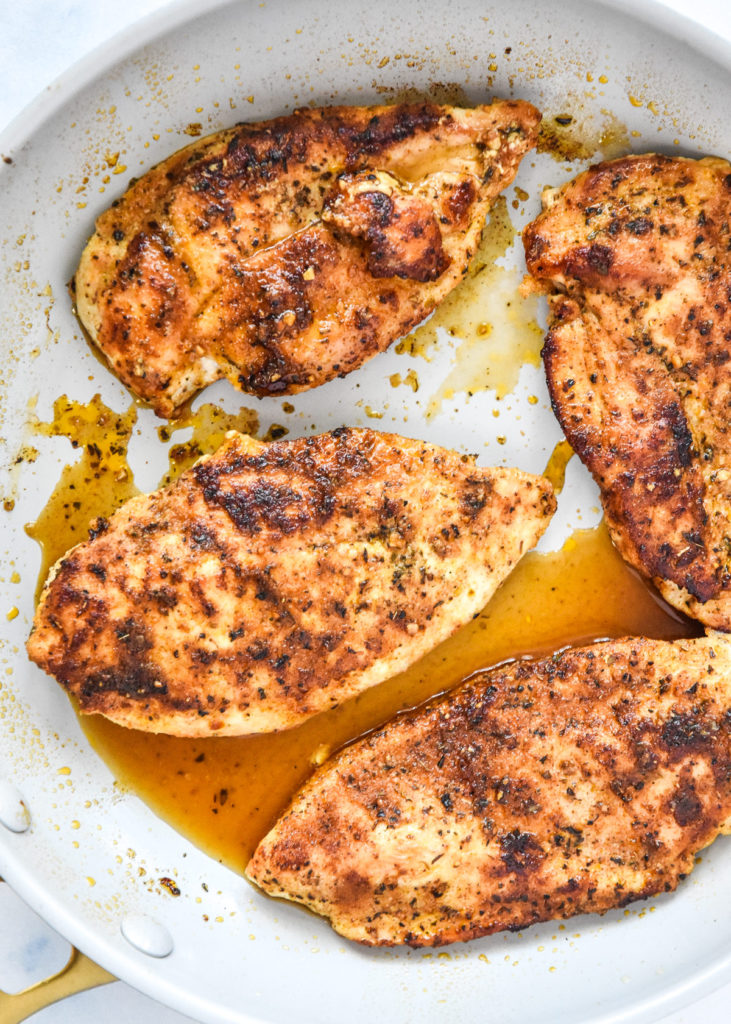 thin sliced stovetop chicken breasts just cooked in a pan.