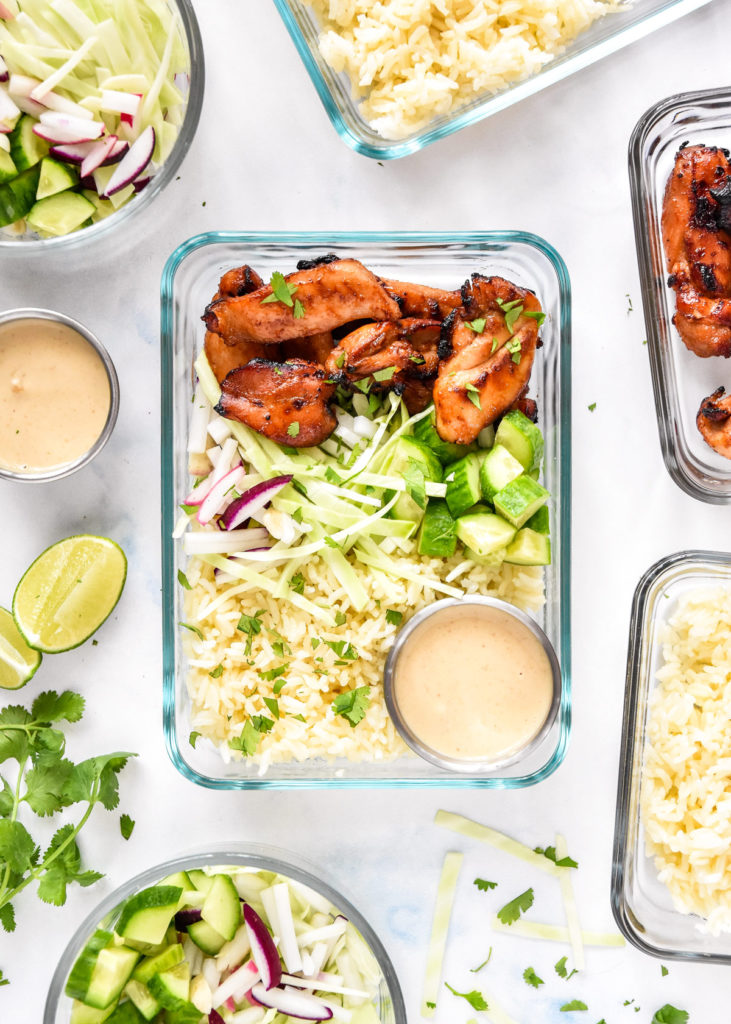 air fryer honey sriracha chicken bowls with dressing and cilantro on top.