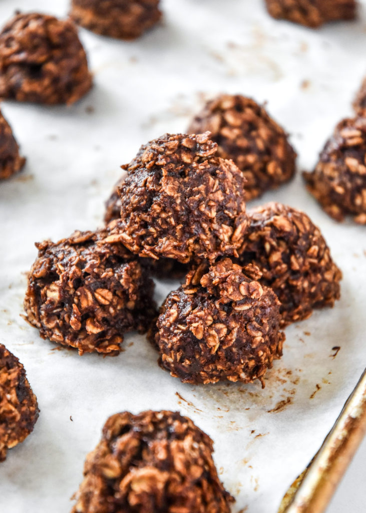 banana chocolate oatmeal mounds stacked on parchment paper.