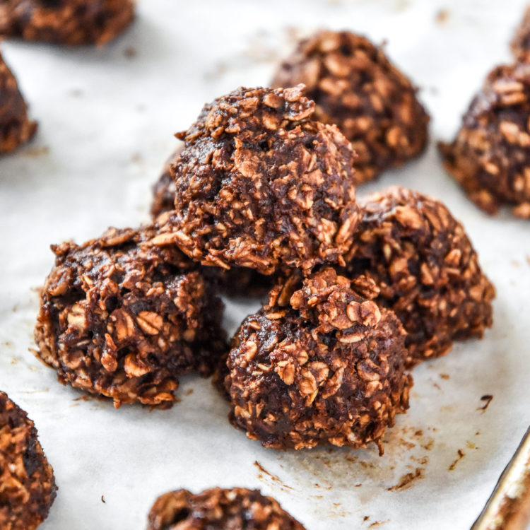 banana chocolate oatmeal mounds stacked on parchment paper.