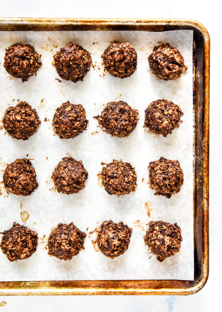 baked banana chocolate oatmeal mounds on a cookie sheet.