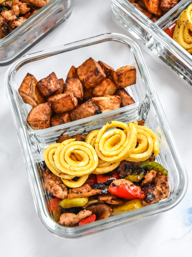 crispy potato egg ribbon breakfast bowl in a glass meal prep container.