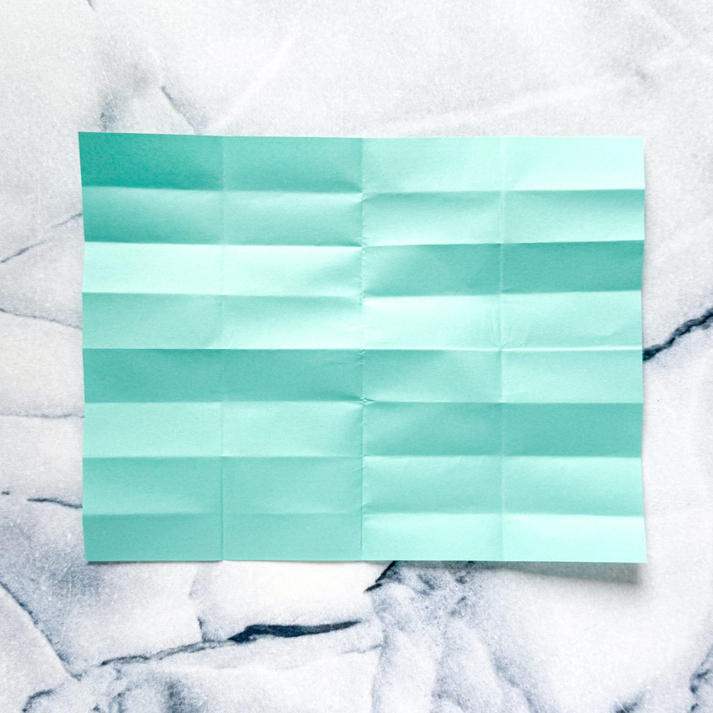 a piece of blue paper with several fold marks.