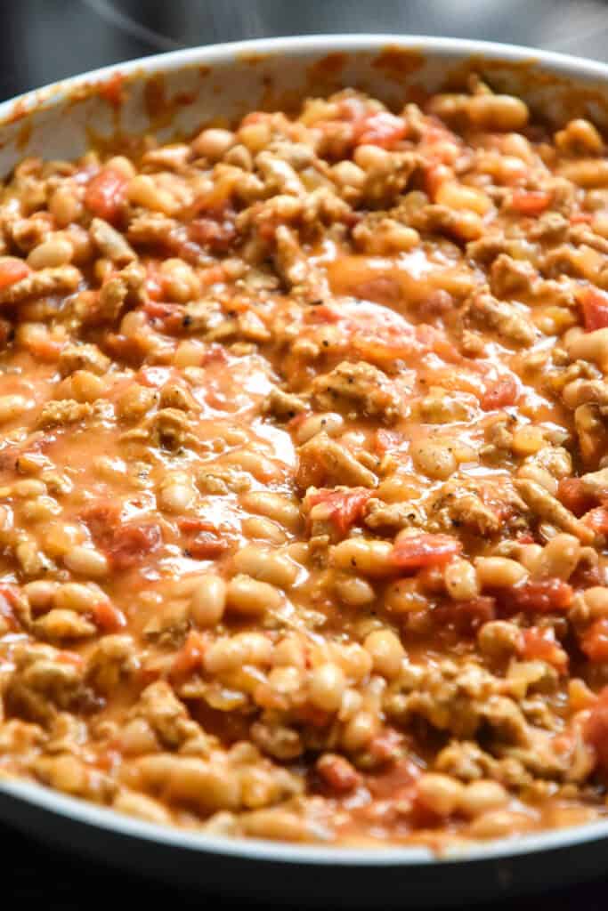 Simmering sloppy white bean turkey skillet on the stovetop.