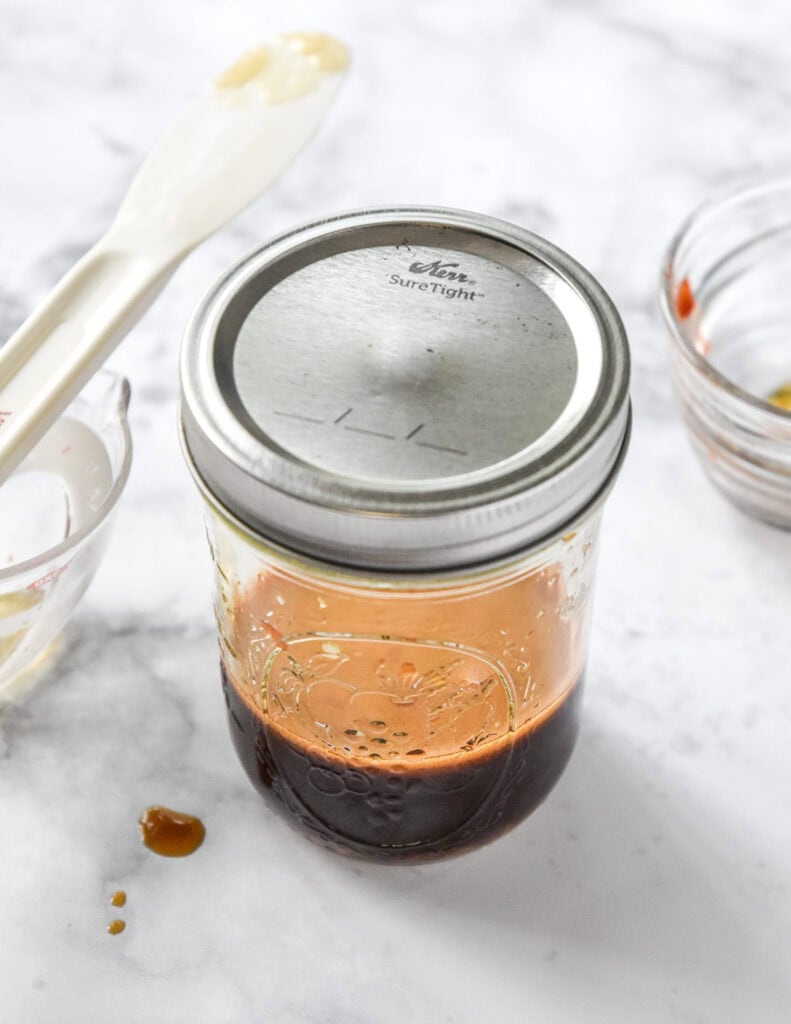 mason jar of soy sauce and other sauce ingredients mixed up.