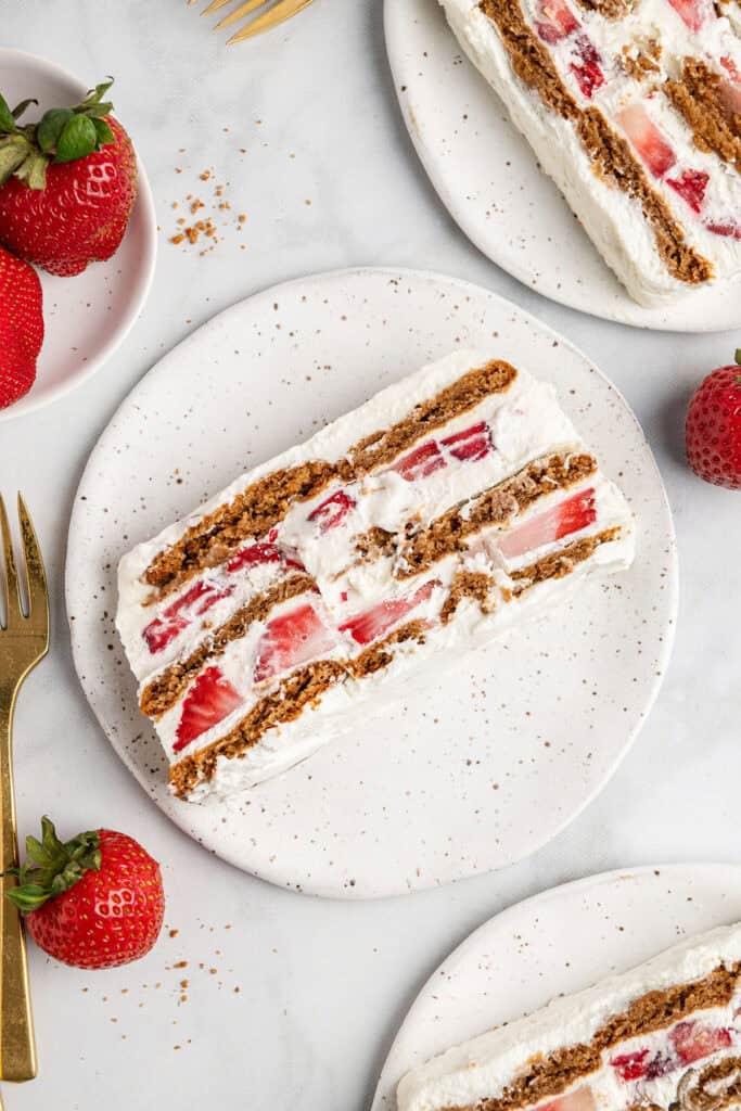a slice of strawberry gingersnap icebox cake on a white plate.