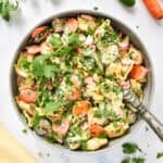 banh mi inspired tortellini salad in a large serving bowl with wooden spoon.