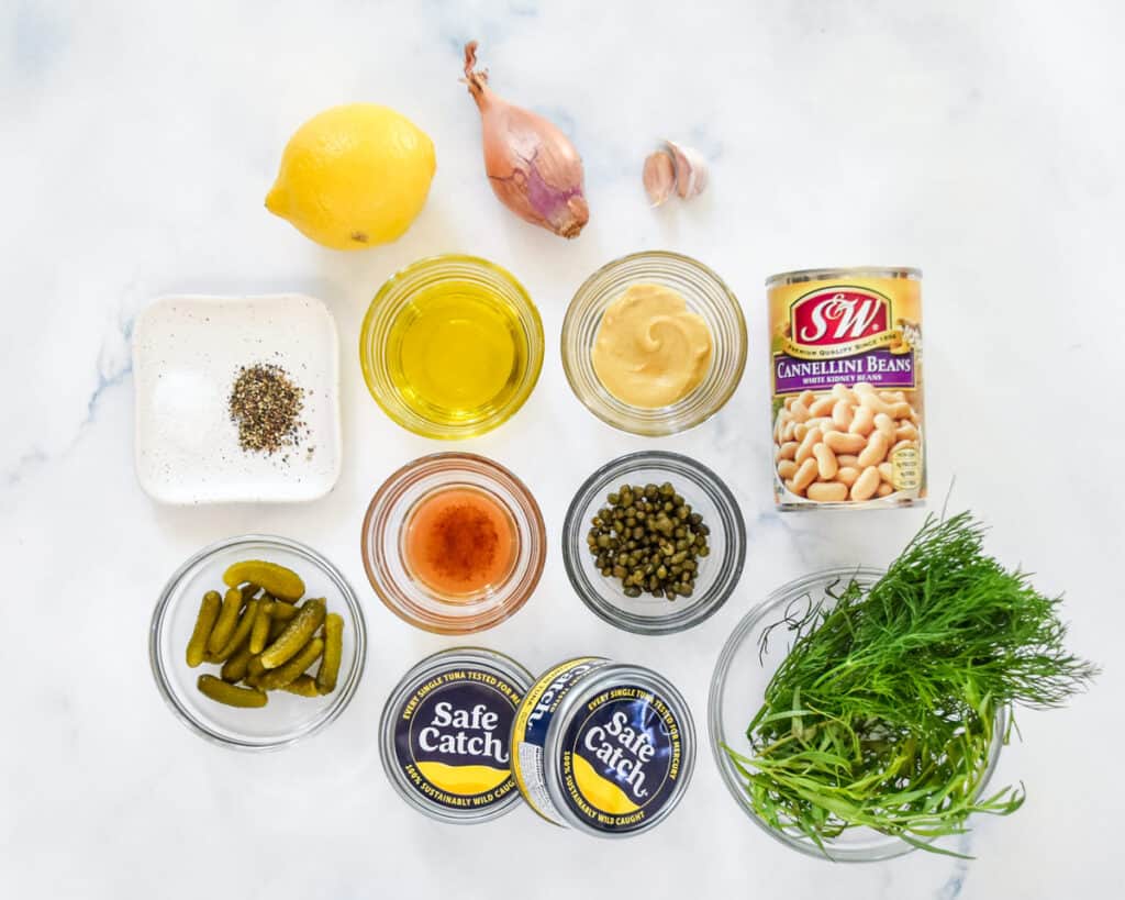 ingredients required to make a tuna white bean salad before mixing everything together.