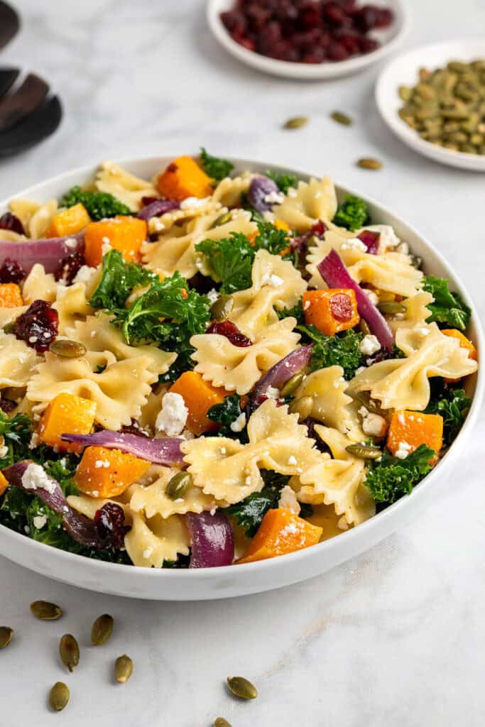 fall pasta salad with maple vinaigrette dressing in a serving bowl.