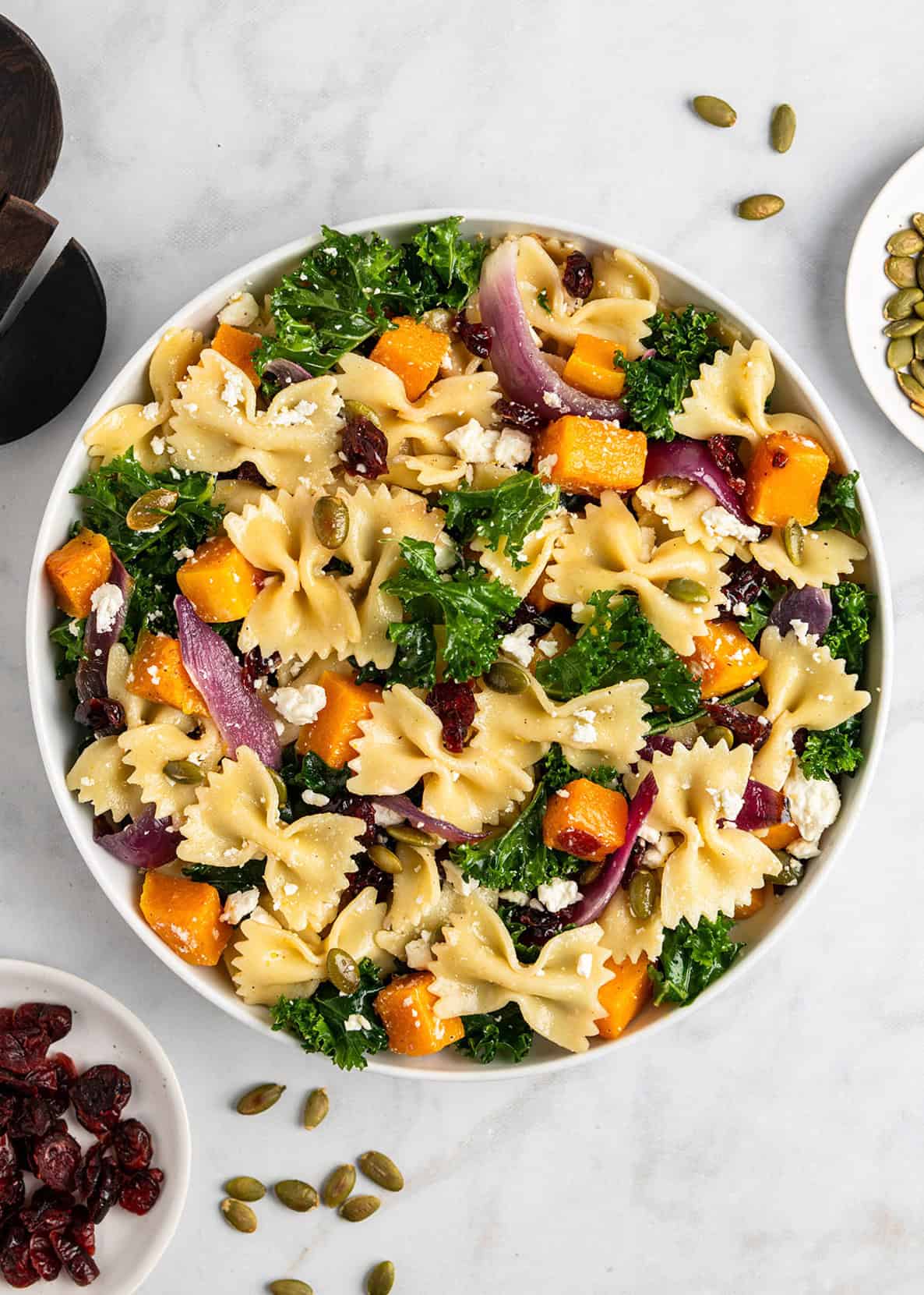 fall pasta salad with maple vinaigrette in a large white bowl.