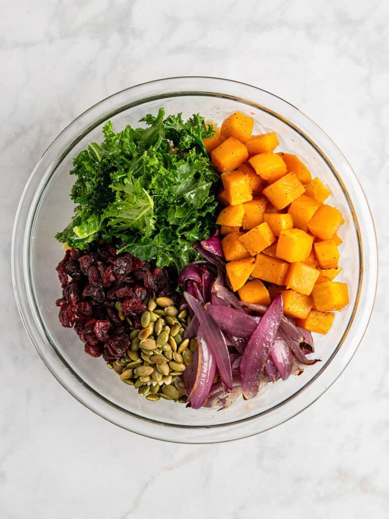 fall pasta salad with maple vinaigrette dressing before mixing everything together.